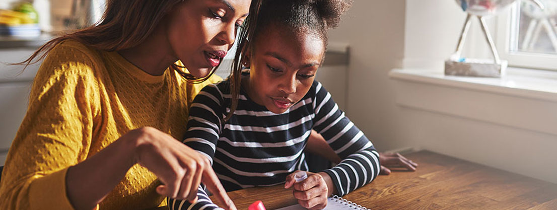 mother helps child with homework