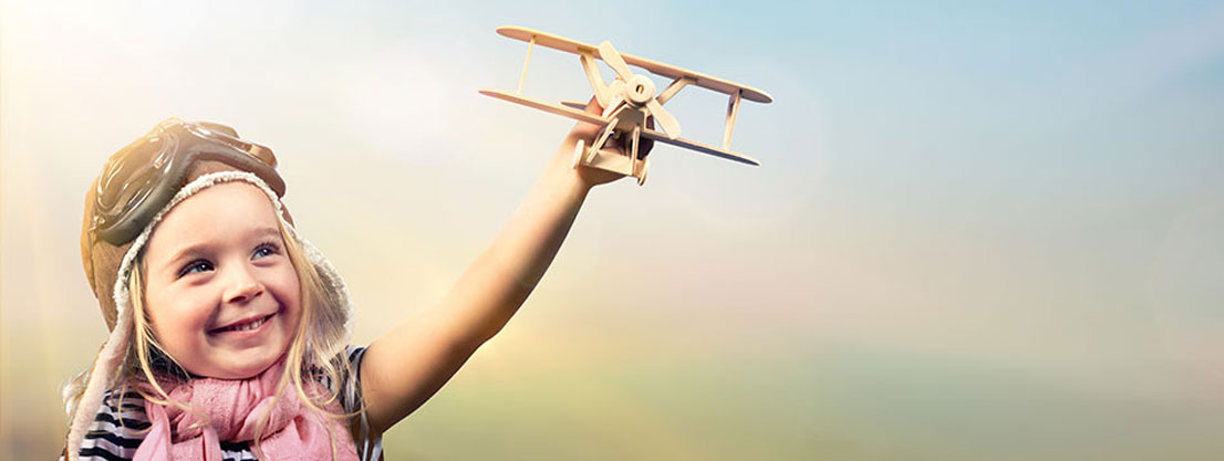 child with minature airplane