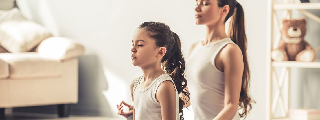 Woman and child meditating together