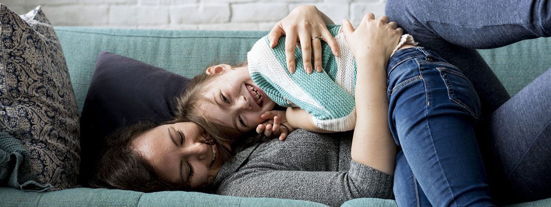 Woman cuddling with child, stress relief