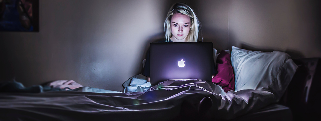 Woman with computer in bed