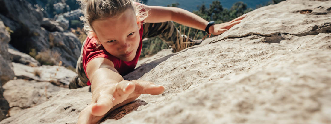 Woman scales mountain wall, power through anger